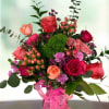 Roses, mini carnations, dianthus, hypericums and greenery.