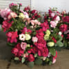 Table floral arrangement made with large roses, lizianthus, vibunium, carnations, and israeli