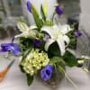 Medium size arrangement with iris, lilies, and lisianthus. 