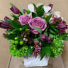 Rustic white ceramic vase 
Contains some beautiful purple tulips, Ecuadorian Lavender roses