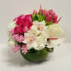 a nice fish bowl vase with some lovely pink roses and nice