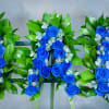 This sympathy standing spray, in the color blue, is a stunning symbol