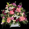 Fully loaded flower arrangement in a white basket.