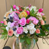 Large, round-style beautiful arrangement of Spring's soft and bright colors in a