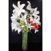 Lashes casablanca Lilies flowing throughout the vase, with a stunning blast of