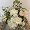 Soft pastel roses, white roses, white hydrangea and ranunculus accented by eucalyptus