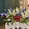 This arrangement is a flat-lying wreath with a space in the center