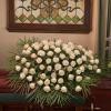 This beautiful casket arrangement of all white roses is often used as