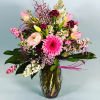 This stunning arrangement has it all; everywhere you look, spring calls its