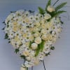 Heart made out of Roses, carnations, daises with some of the greenery.