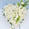 Heart made out of Roses, carnations, daises with some of the greenery.