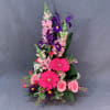 This cheerful high style arrangement is full of Roses, Gerbera Daisies, and