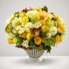 A beautiful vase of yellow flowers blended with fresh cut lemons.