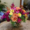 Colors galore of bright orange and yellow roses, shades of pink Stock