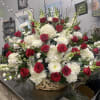 Beautiful classic red and white funeral basket arrangement. 
Version shown is the