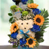 Sunflowers, blue roses, green spiders, statice, baby&#039;s breath and greenery.