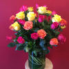 3 dozen mixed colored roses arranged perfectly in a clear glass vase
