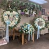 LARGE CASKET PIECE FILLED WITH WHITE AND BLUE ROSES, GREENERY BACKROUND, OPEN
