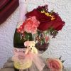 Bottle of pear cider, accompanied by a glass decorated with hearts, fresh