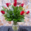 1dz Roses arranged in a glass vase with fillers and greens, 60cm