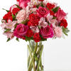 Blushing shades of pink blooms are nestled in lush greens to charm