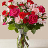 Blushing shades of pink blooms are nestled in lush greens to charm