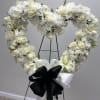 Our heartfelt heart-shaped standing spray sympathy floral arrangement, a tender tribute to