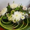 This all-white floral arrangement with the green swirl is a fun way