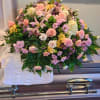 A beautiful mix of sping colors using pink roses/carnations, white carnations, pink
