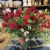 This luxurious arrangement of gorgeous roses, premium greens and other beautiful blooms