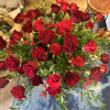 This luxurious arrangement of gorgeous roses, premium greens and other beautiful blooms