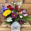 A beautiful fresh garden arrangement featuring whimsical butterflies, arranged in a charming