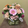 Clear short vase filled a spring variety of beautiful florals