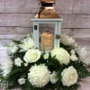All white blooms surrounding a beautiful keepsake lantern with varying sentiments. All