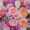 Different shade of pink flowers are carefully arranged inside the flower box.