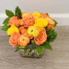 Gift this vibrant bouquet with roses and ranunculi to your friends and