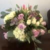 White hydrangea, tulips, lavender roses all together in a bubble bowl