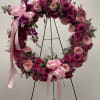 A stunning open circle standing spray adorned with various shades of pink