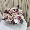 This picture-perfect arrangement of pink, white, and purple roses embodies the feeling