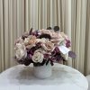 This picture-perfect arrangement of pink, white, and purple roses embodies the feeling