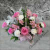 Various shades of pink flowers with touches of white make this basket