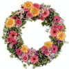 A pure and delicate expression of adoration. This wreath of orange, lavender