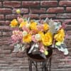 composed of Dusty miller, peach stock, white tulips and yellow roses. comes