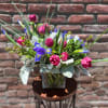 Composed of one dozen purple or blue iris, Dark pink tulips, dusty