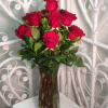 Arranged to impress! One dozen premium long stemmed red roses elegantly vased