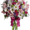 A mix of fresh flowers such as spray roses, daisy and button