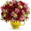 This bouquet features red roses, pink alstroemeria, miniature red carnations, miniature light