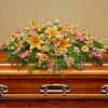 Pay your respects with a divine mix of pink and yellow blossoms