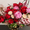 Composed of roses, spray roses, orchids, peonies, astilbe, variety of green.