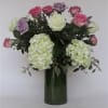 3 colors of roses arranged in a vase. 